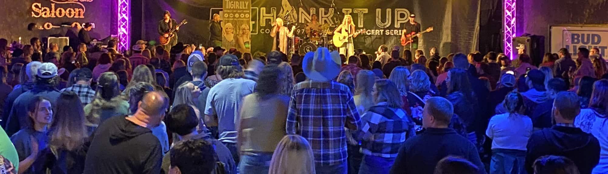 country concert with fans wearing cowboy hats Detroit